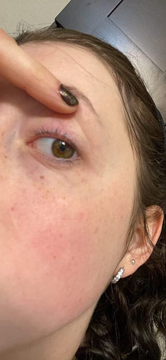 a reviewer's photo demonstrating clean skin and lashes after use