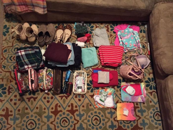A reviewer's piles of clothes and shoes ready to be packed