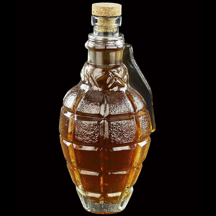 The glass decanter with its cork stopper, ideal for preserving your liquor.