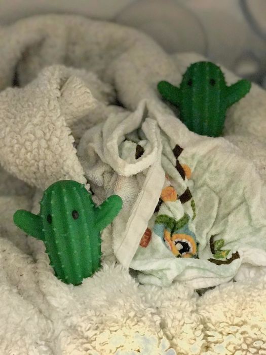 The green dryer balls placed in a reviewer's stack of towels