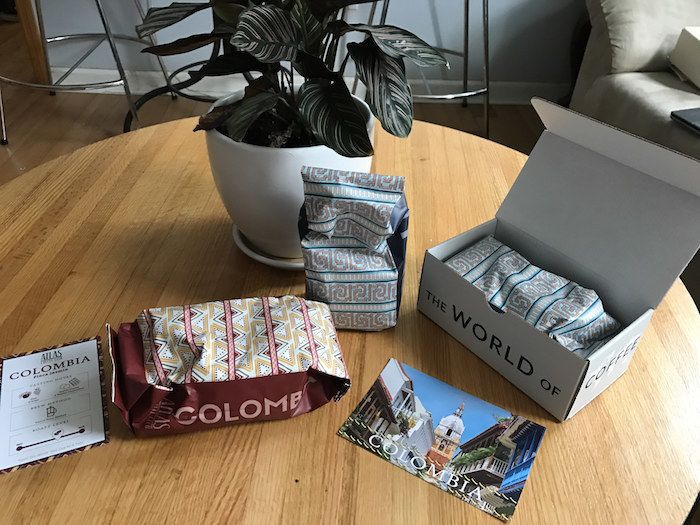The box containing bags of coffee beans and informational postcards