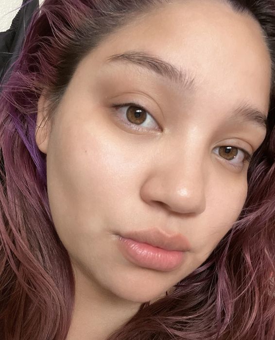 The reviewer with a clean, makeup-free face after using the cleansing balm