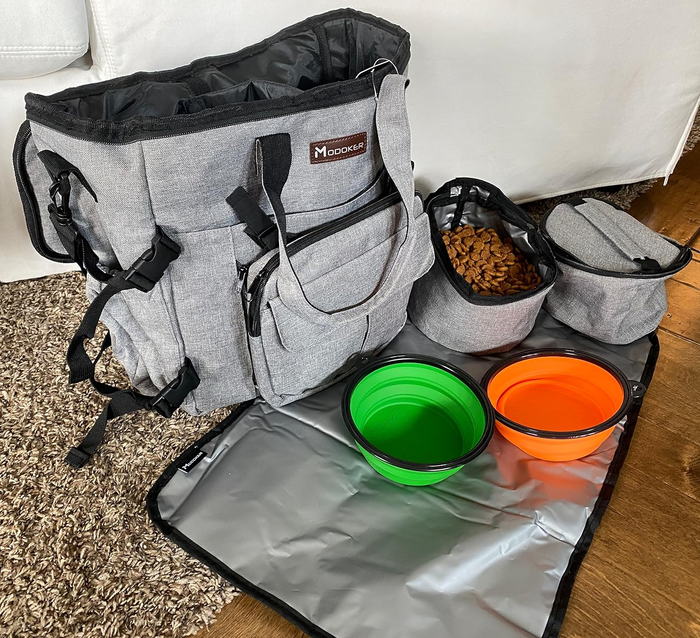Multi-compartment pet travel bag featuring foldable bowls and a feeding mat for easy and organized trips