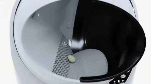 A Litter Robot captured mid-cleaning cycle