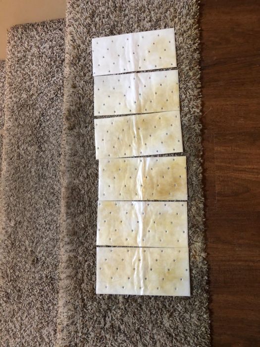 multiple Stomp 'N Go pads placed on stairs, soaking up a brownish stain