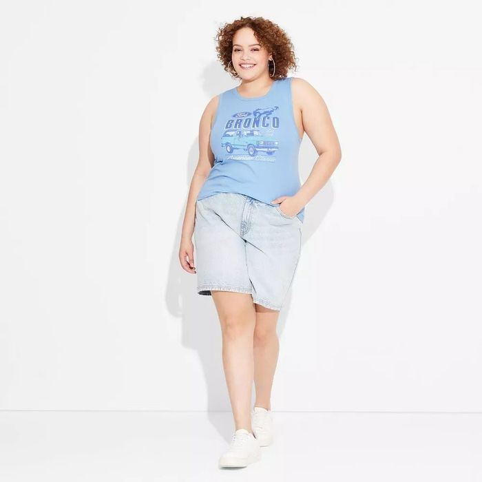 A smiling individual models the sneakers, showcasing their style and comfort.