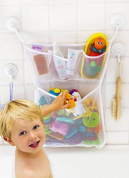 A mesh organizer filled with bath toys, securely attached to the wall