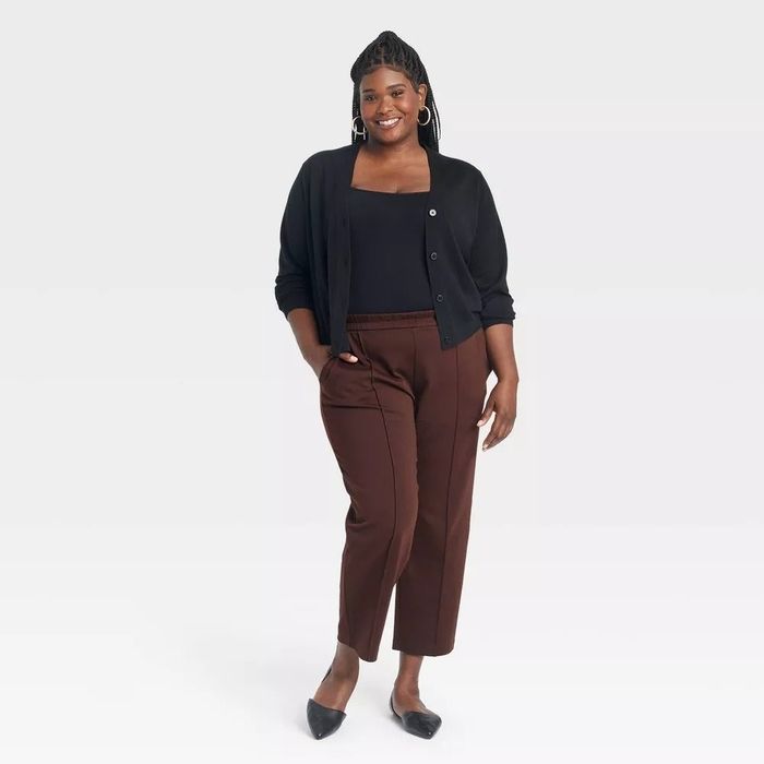 A model showcases a chic, casual ensemble consisting of a square-neck top, an open-front cardigan, and high-waisted trousers.