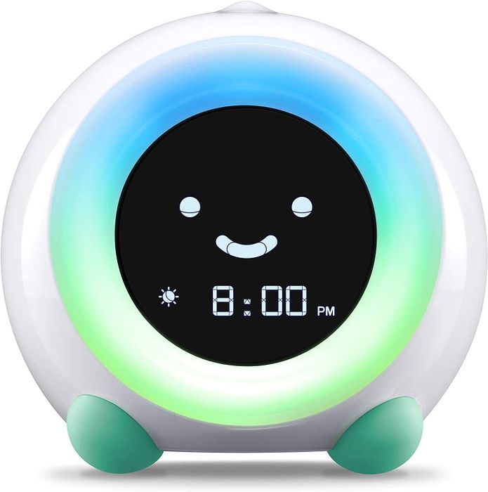 The clock glowing in green and teal with a cheerful smiley face