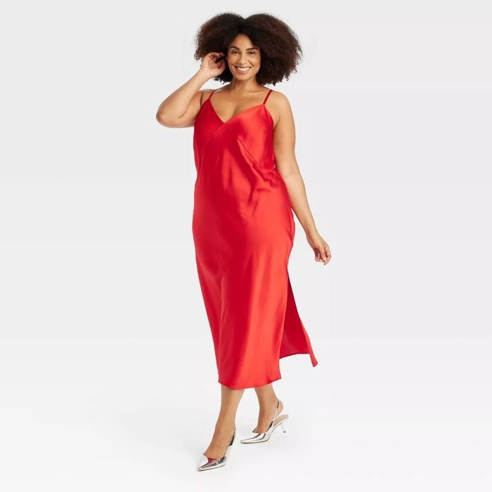 a model wearing the red slip dress paired with high heels