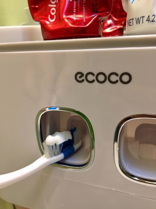 A photo from a reviewer showing toothpaste being dispensed onto a toothbrush