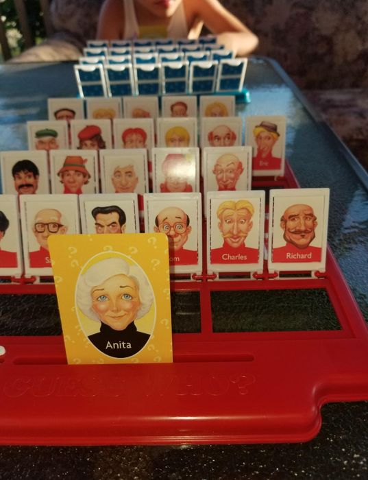 a reviewer's Guess Who board game displaying the character cards