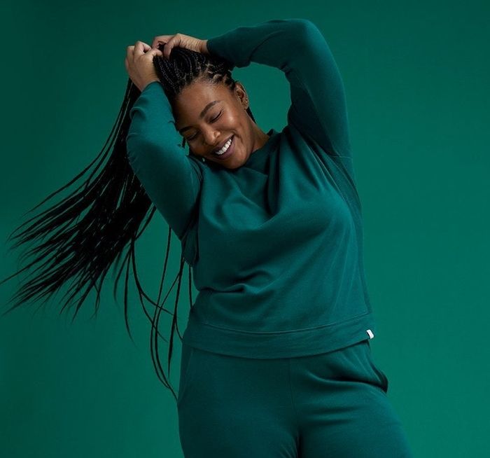 A model showcasing the green sweatshirt