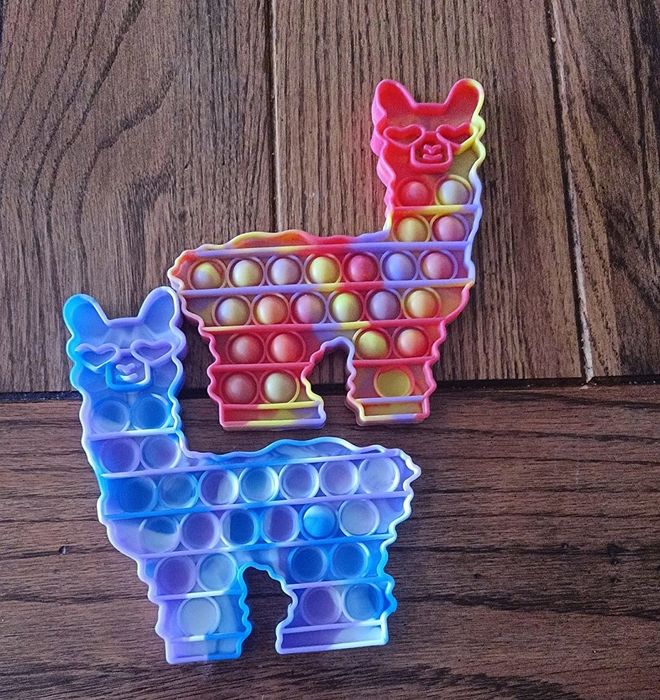 A reviewer's image showing two colorful llama-shaped fidget toys.