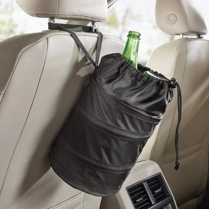 A backseat organizer that hangs from the headrest, neatly holding a green glass bottle.