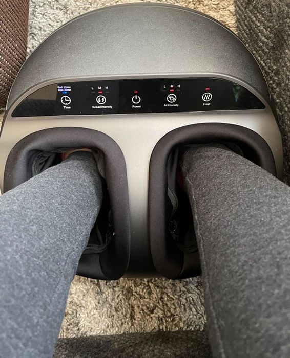 A reviewer enjoying the foot massager
