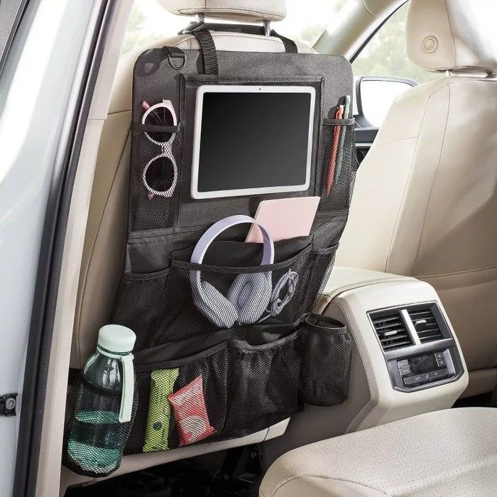 A car seat organizer with multiple pockets, holding a tablet, sunglasses, headphones, a water bottle, and more.