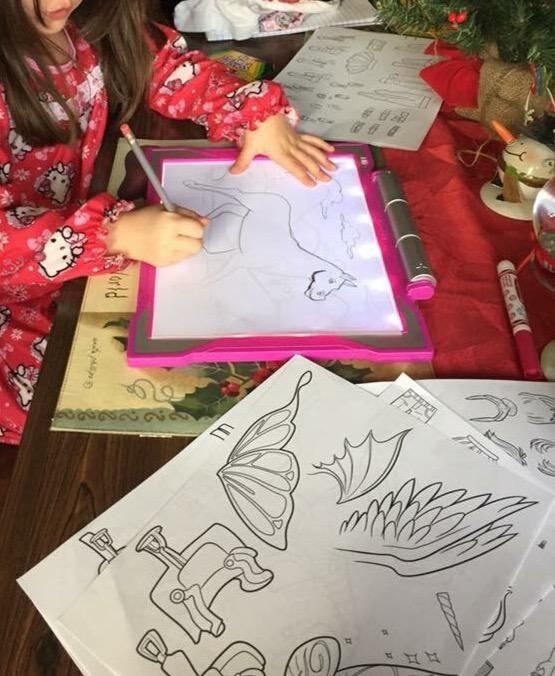 A photo of a child engaged in play with a drawing pad, shared by the reviewer.