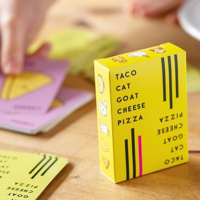 the game box with cards spread out in the background
