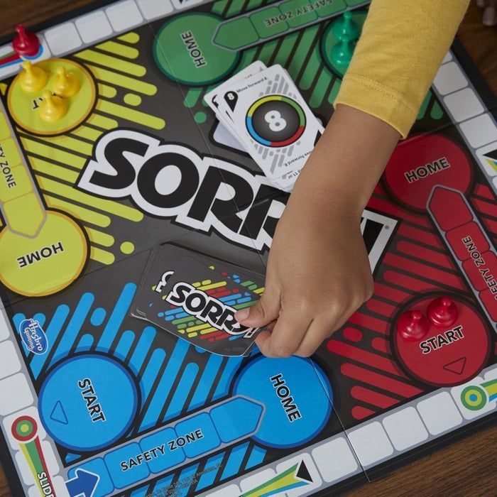 A child model playing the Sorry! board game, selecting a card