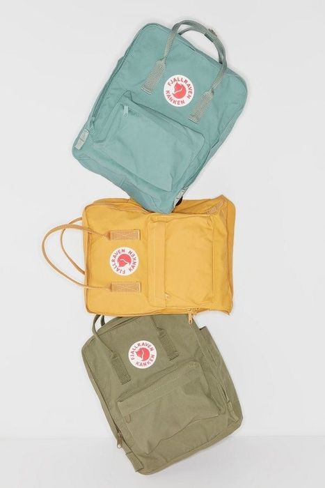 teal, yellow, and olive green backpacks with a somewhat cube-like design