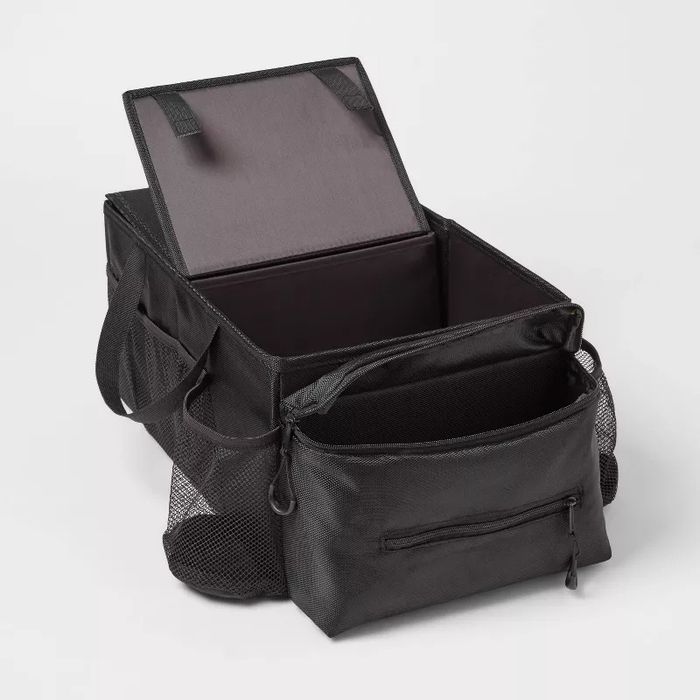 A spacious black storage bag featuring side pockets and a zippered front pocket, designed to help you stay organized and store your belongings efficiently.