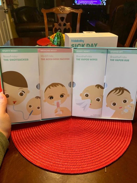 Fridababy Sick Day kit featuring NoseFrida, MediFrida, BreatheFrida Vapor Wipes, and Vapor Rub packaging displayed on a table.