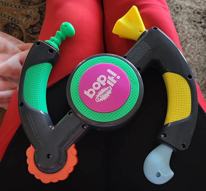reviewer's Bop It toy resting on their lap
