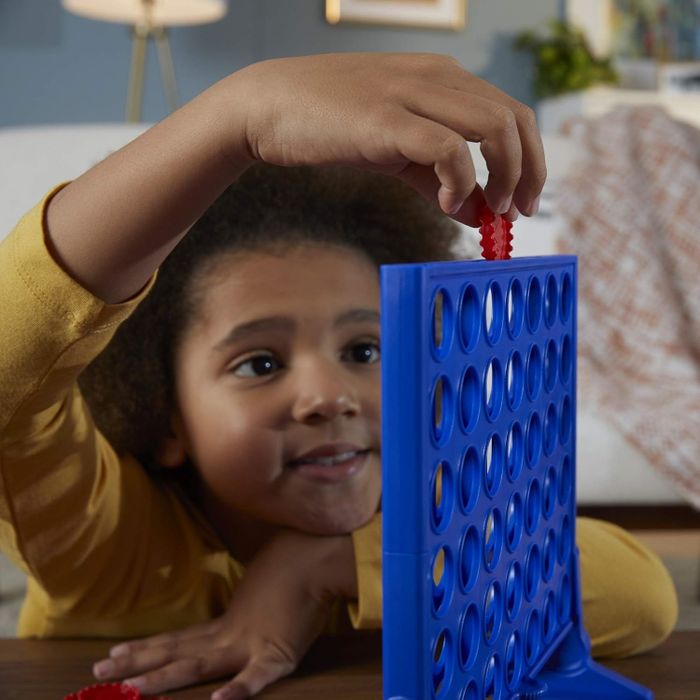 a child model engaged in a game of Connect Four