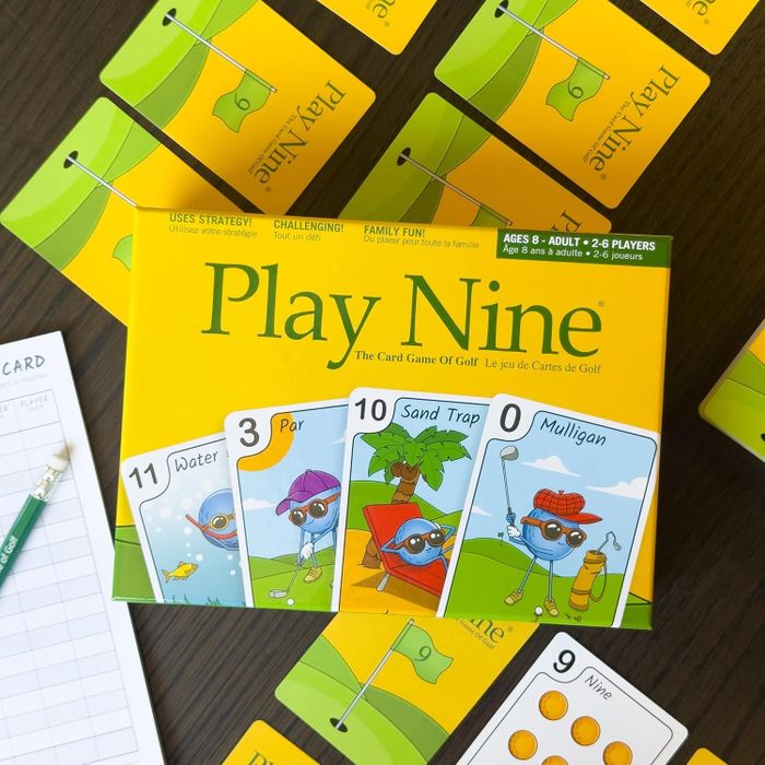 Play Nine card game box and cards laid out on a table