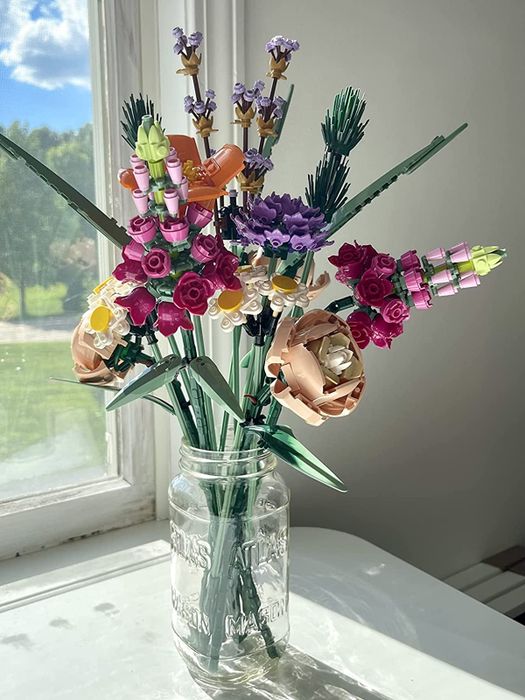 a mason jar containing the assembled Lego flowers