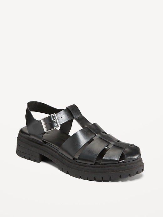 A black leather sandal with a chunky sole and a buckle design