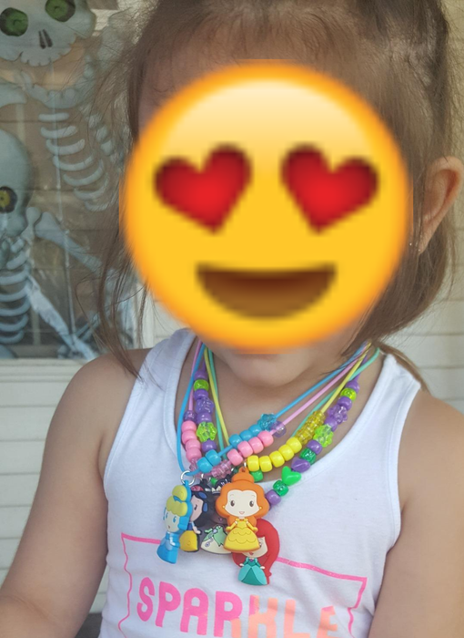 A photo of a reviewer’s child wearing several necklaces from the kit