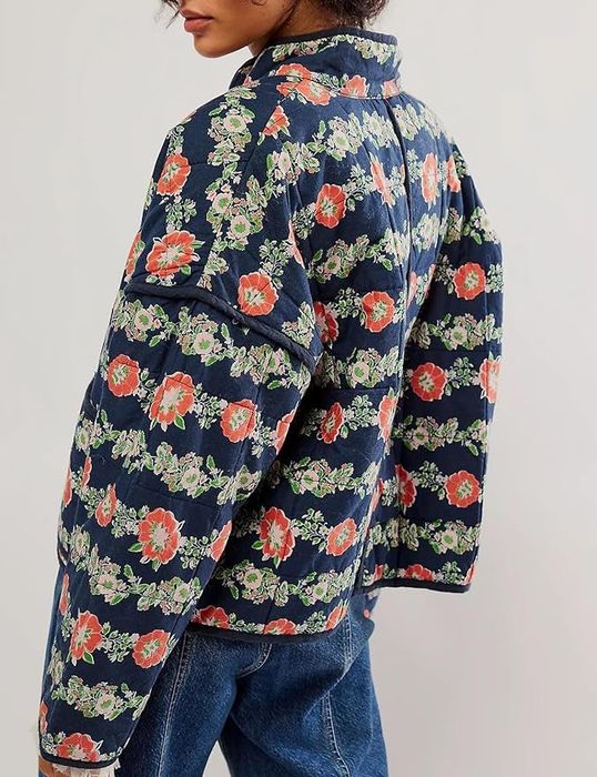 model showcasing the jacket in a vibrant red and blue floral pattern