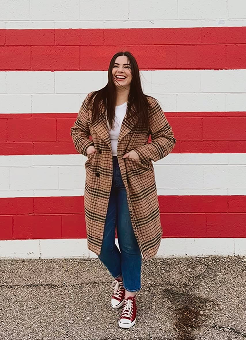 reviewer showcasing the coat in a classic tan shade