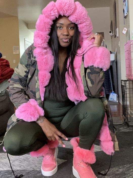 reviewer wearing a camo and pink parka