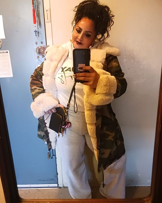 reviewer wearing a camo and cream parka