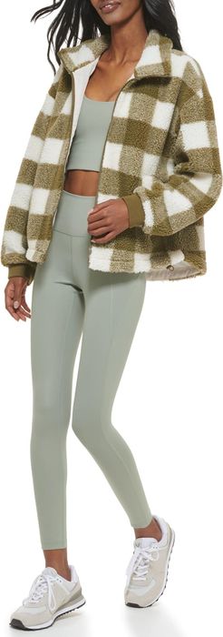 front-facing view of a model wearing a green plaid jacket