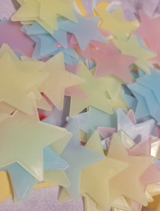 A reviewer's photo showing a glowing dino decal on the wall