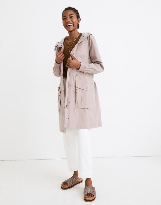 Model wearing a dusty pink raincoat.
