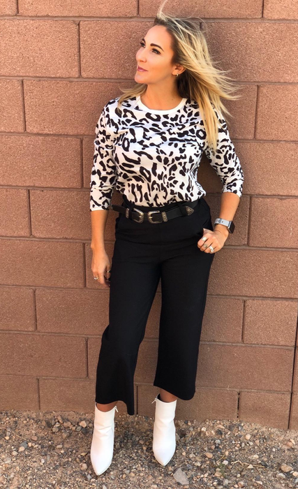 A reviewer photo featuring the black capris in a stylish pose