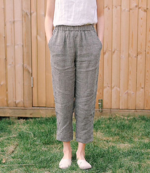 A model is seen wearing the black and white plaid gingham pants.