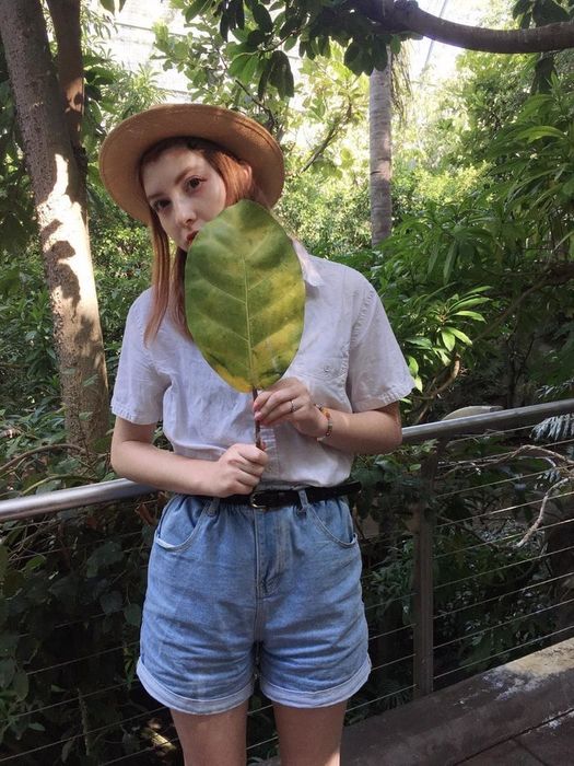 A reviewer styling high-waisted denim shorts.