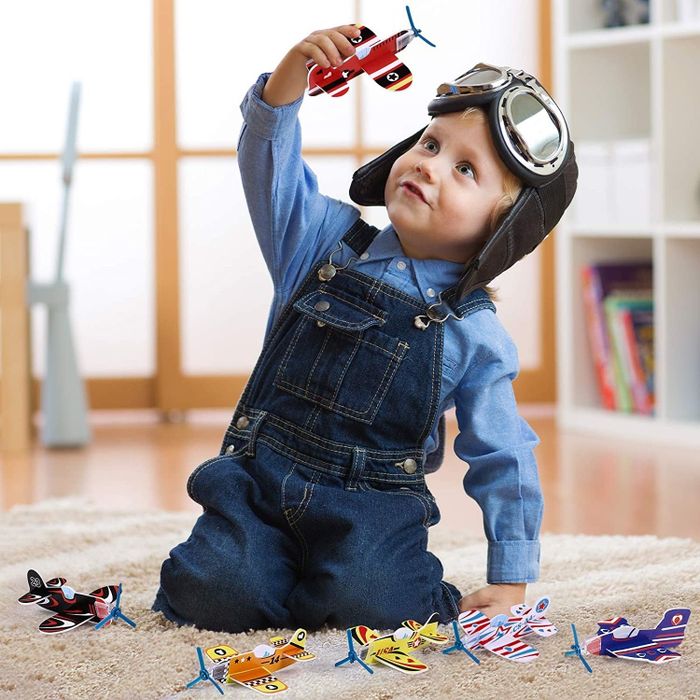 A child happily playing with the foam airplanes.
