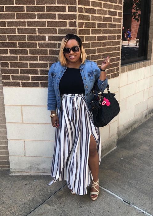 A reviewer rocking the pants and showing off the stylish side slit.