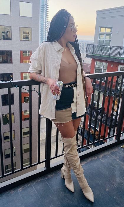 Reviewer styled in a cream shirt layered over a top and skirt combination.