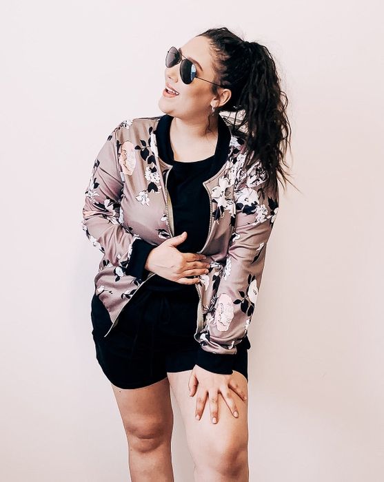 Reviewer showcasing the grey/green floral jacket