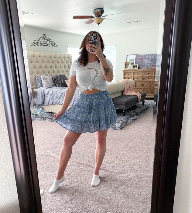 A reviewer showcasing the skirt in a lovely shade of blue.