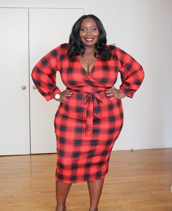 The reviewer is wearing the dress in a bold red plaid pattern.