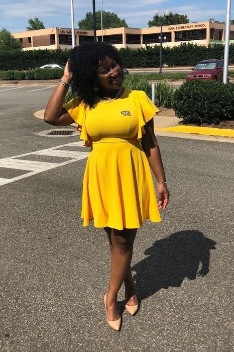 A reviewer wearing the yellow dress.